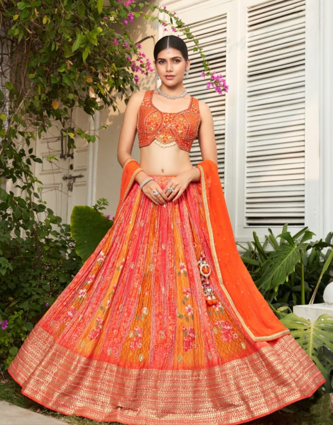 Likely raw silk or heavily embroidered silk Ornately embroidered with mirror work, sequins, and threadwork